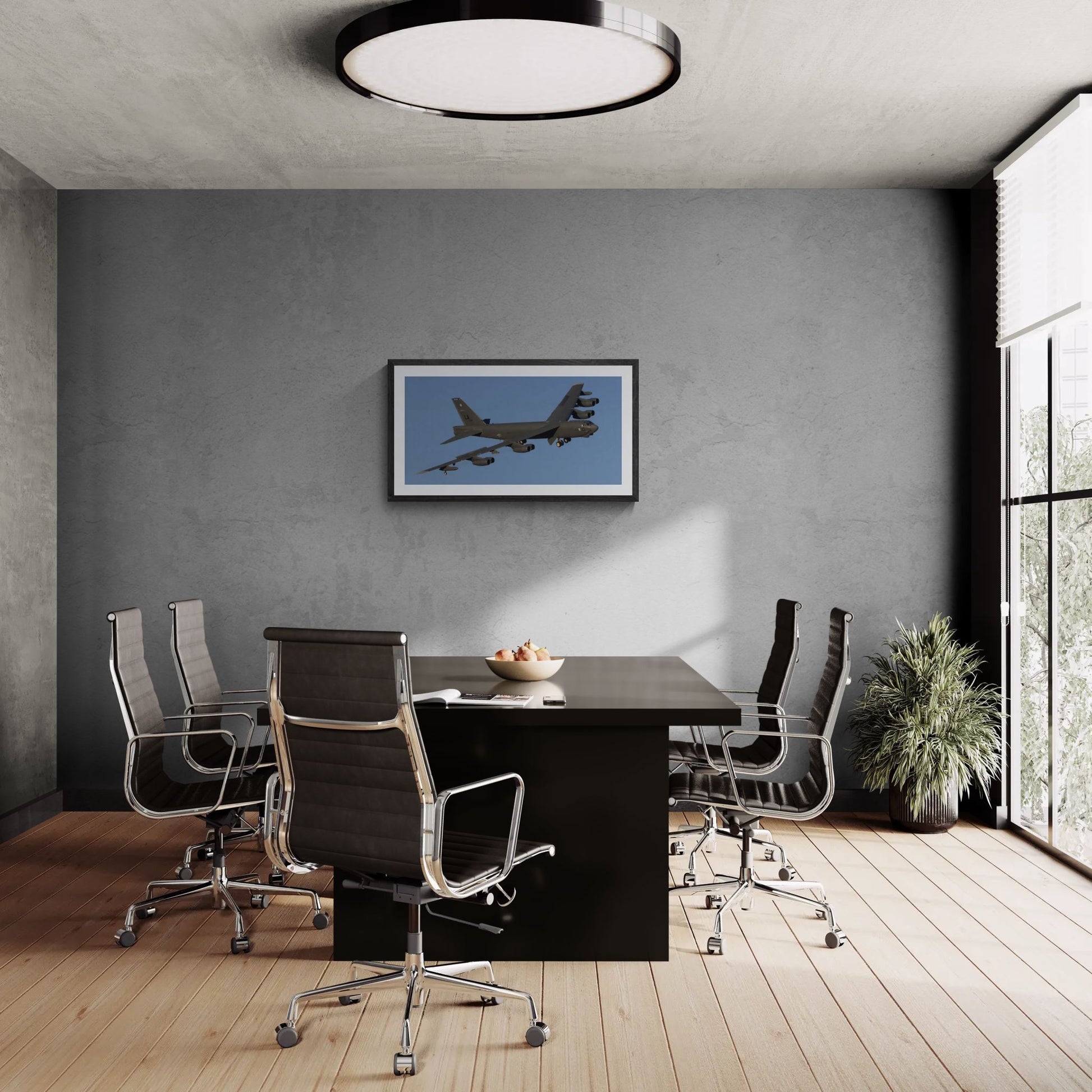 A large-format 40x20 "Statement Edition" of the "B-52 Stratofortress: The Industrial Titan" print anchored in a professional boardroom. The B-52 aviation art is displayed on a textured grey feature wall, showcasing the massive scale and industrial engineering of the aircraft in a luxury office environment.