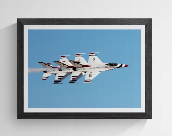 Limited edition U.S. Air Force Thunderbird F-16 photography print titled "Echelon Alpha" by Phil Schmauder at Nellis AFB. The master print, featuring three jets in a tight echelon formation, is professionally presented in a textured black gallery frame with a wide white mat against a light gray background.