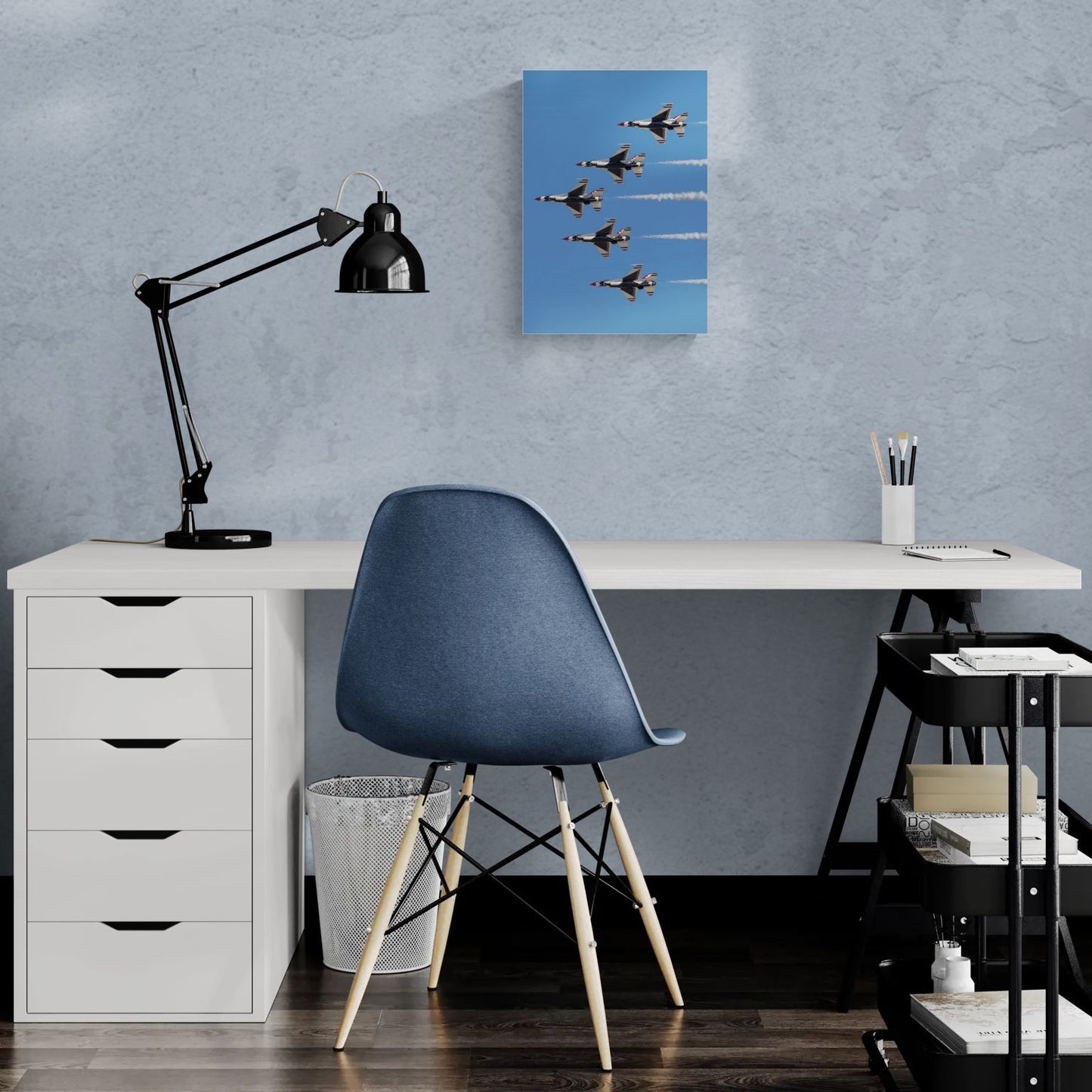 Modern home office desk setup featuring a vertical, clean-edge high-gloss aluminum aviation print titled Delta Prime hanging centered on a light-textured wall as premium pilot-inspired office decor.