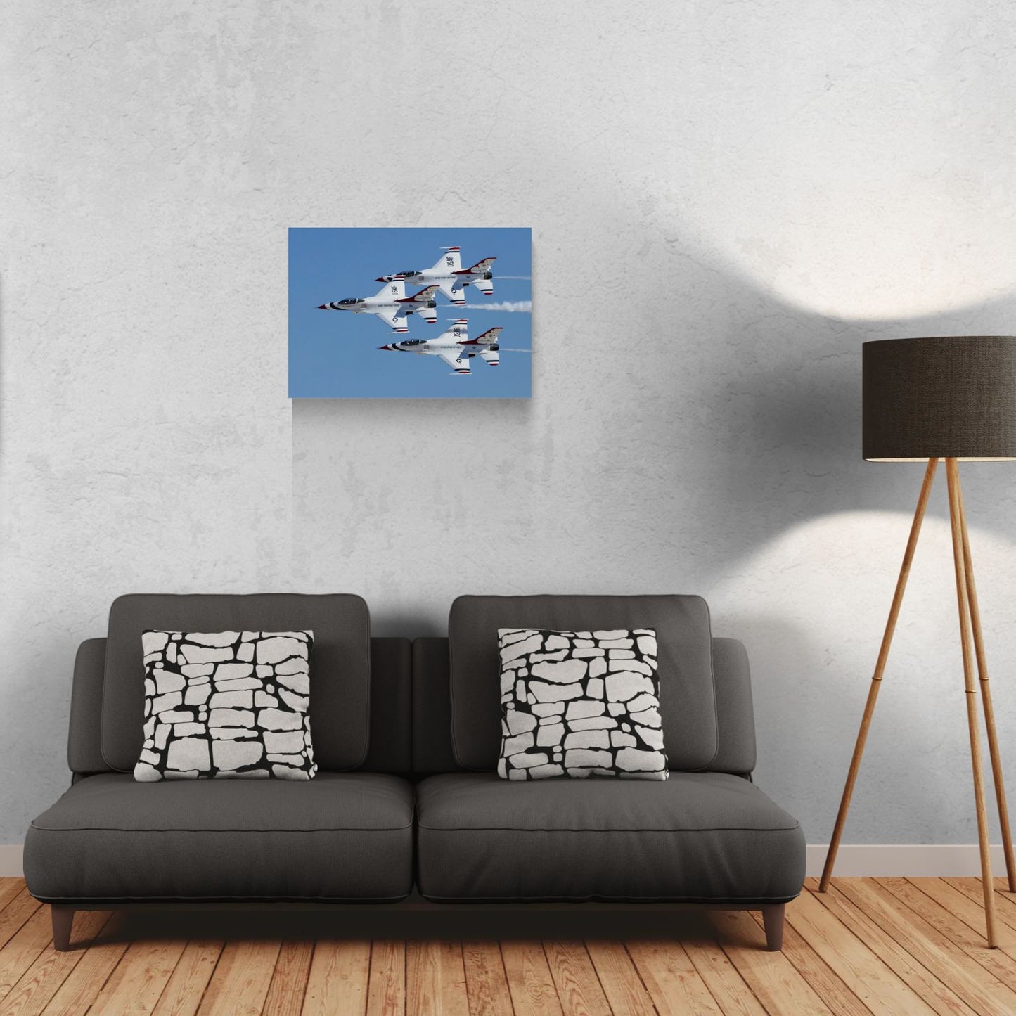 Contemporary living room interior design showcasing a large-format high-gloss aluminum panel print of military fighter jets hanging frameless over a dark grey couch, highlighting the sleek profile of the PES Editions metal collection.