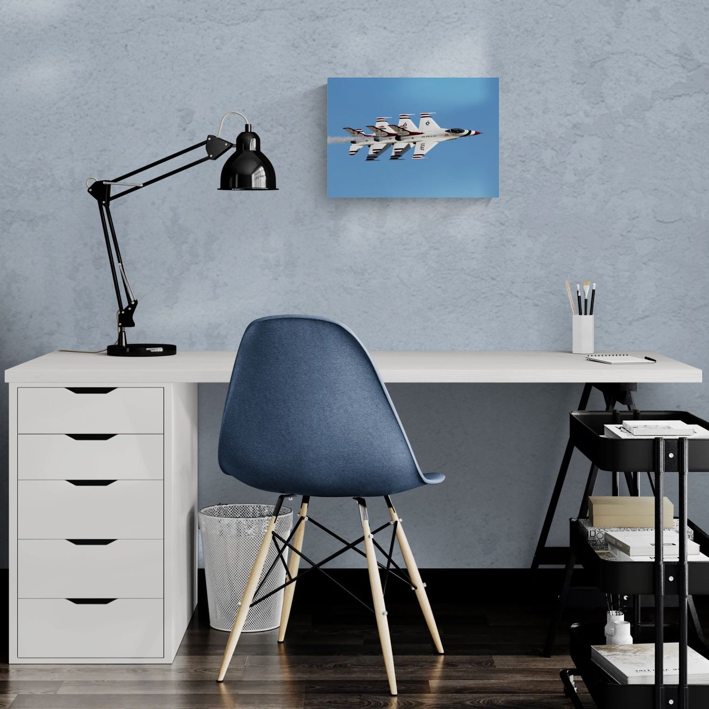 Minimalist creative workspace featuring a frameless, float-mount aluminum aviation print titled Echelon Alpha by PES Editions, hanging as sharp wall decor on a textured surface behind a modern white desk.