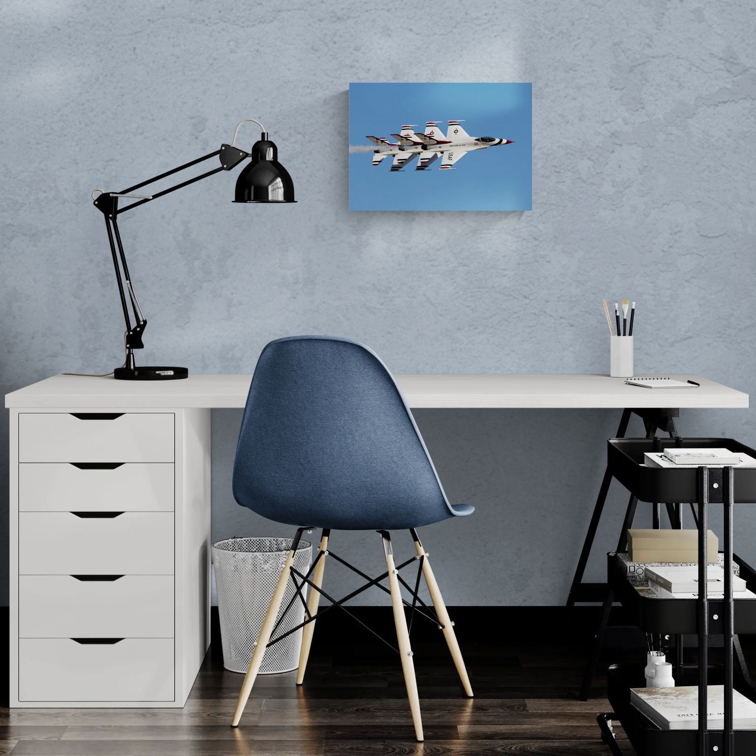 Minimalist creative workspace featuring a frameless, float-mount aluminum aviation print titled Echelon Alpha by PES Editions, hanging as sharp wall decor on a textured surface behind a modern white desk.