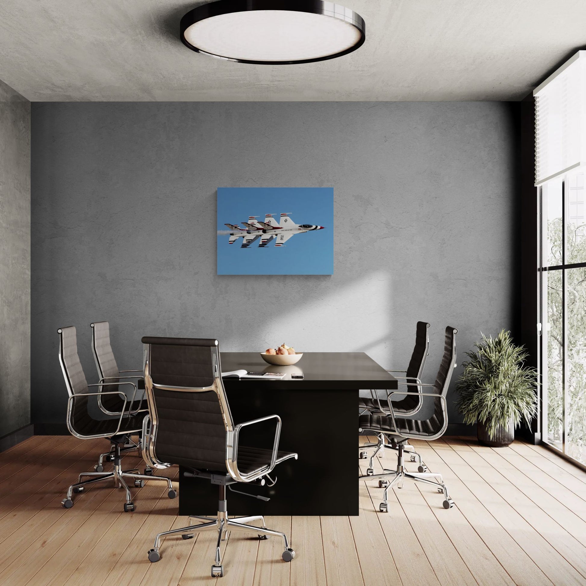Corporate office interior featuring a massive, frameless Statement Edition metal print of the Thunderbirds 3-ship echelon pass, showing pristine tactical grit on a dark concrete boardroom accent wall.
