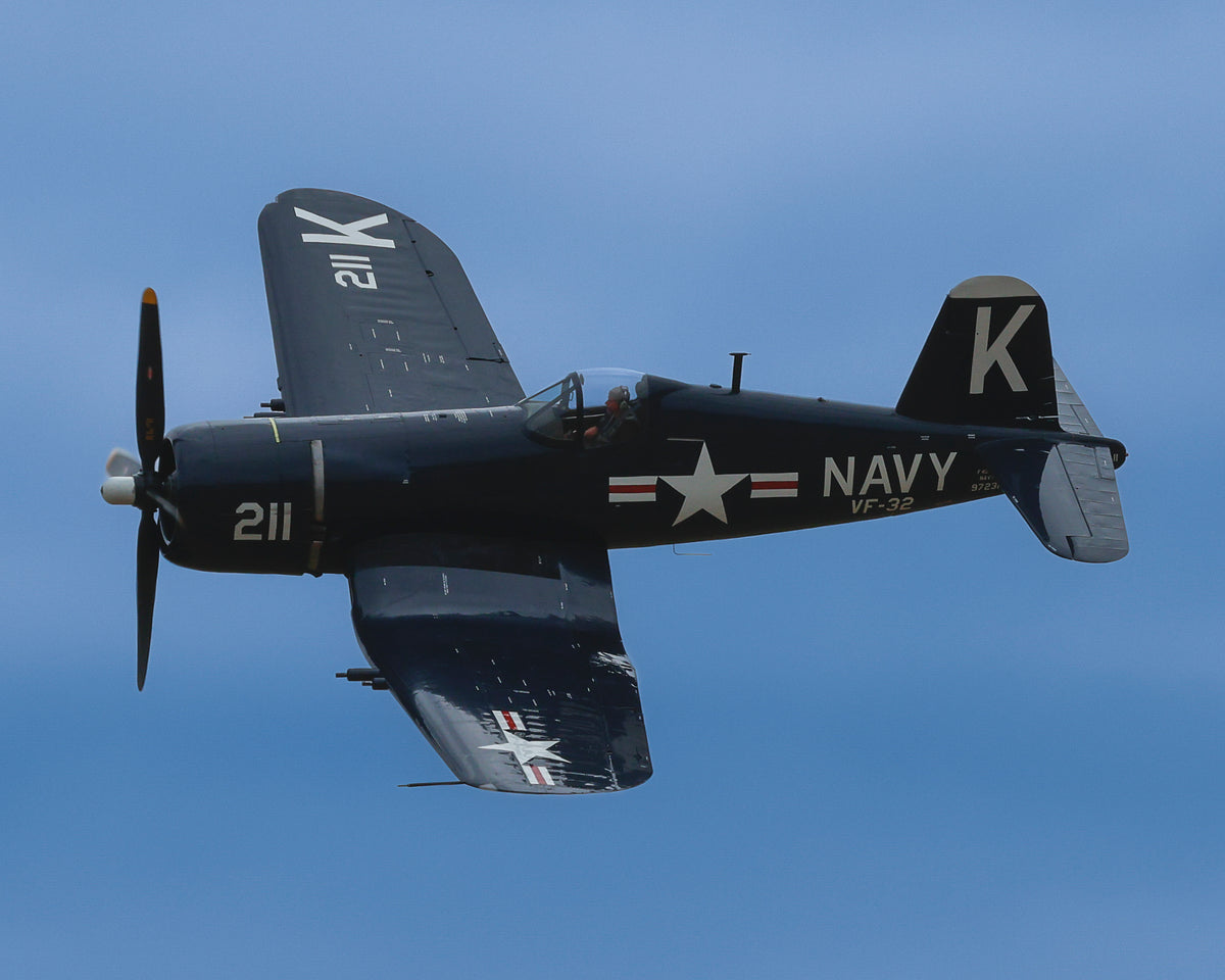 Vought F4U Corsair fighter in Glossy Sea Blue executing a hard topside turn against clear blue sky, fine art warbird print by Phil Schmauder.