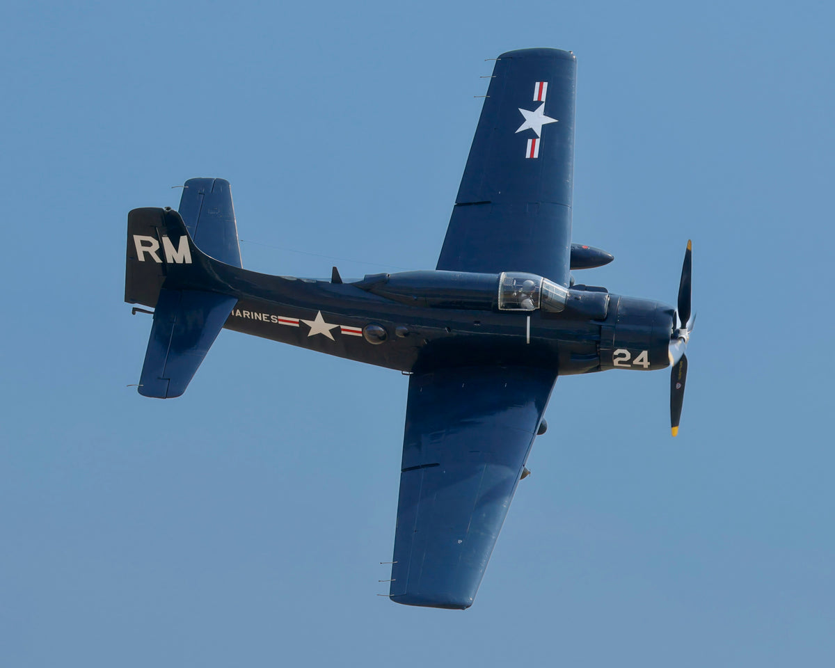 Open edition fine art print of a Douglas A-1 Skyraider banking overhead in blue sky, aviation photography by Phil Schmauder.