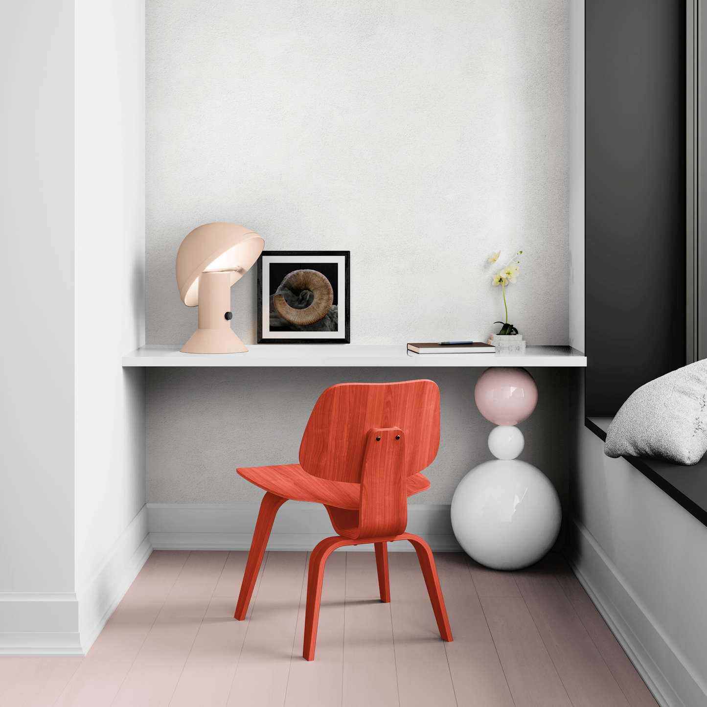 Small framed print of The Curl bighorn sheep horn artwork resting on a minimalist white office desk next to a modern beige desk lamp.