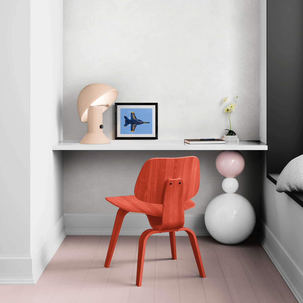 Framed Solo Knife-Edge Pass military jet photograph displayed on a contemporary white desk with a terracotta chair and architectural lamp.