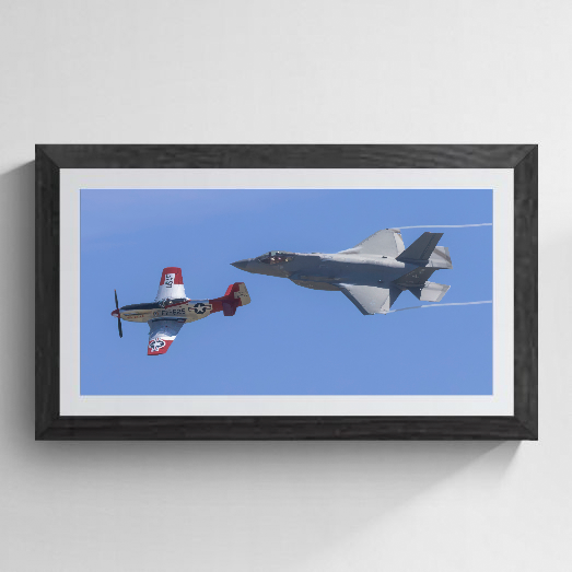 Fine art print of a USAF Heritage Flight featuring a vintage P-51D Mustang and a modern F-35A Lightning II in close formation against a clear blue sky.