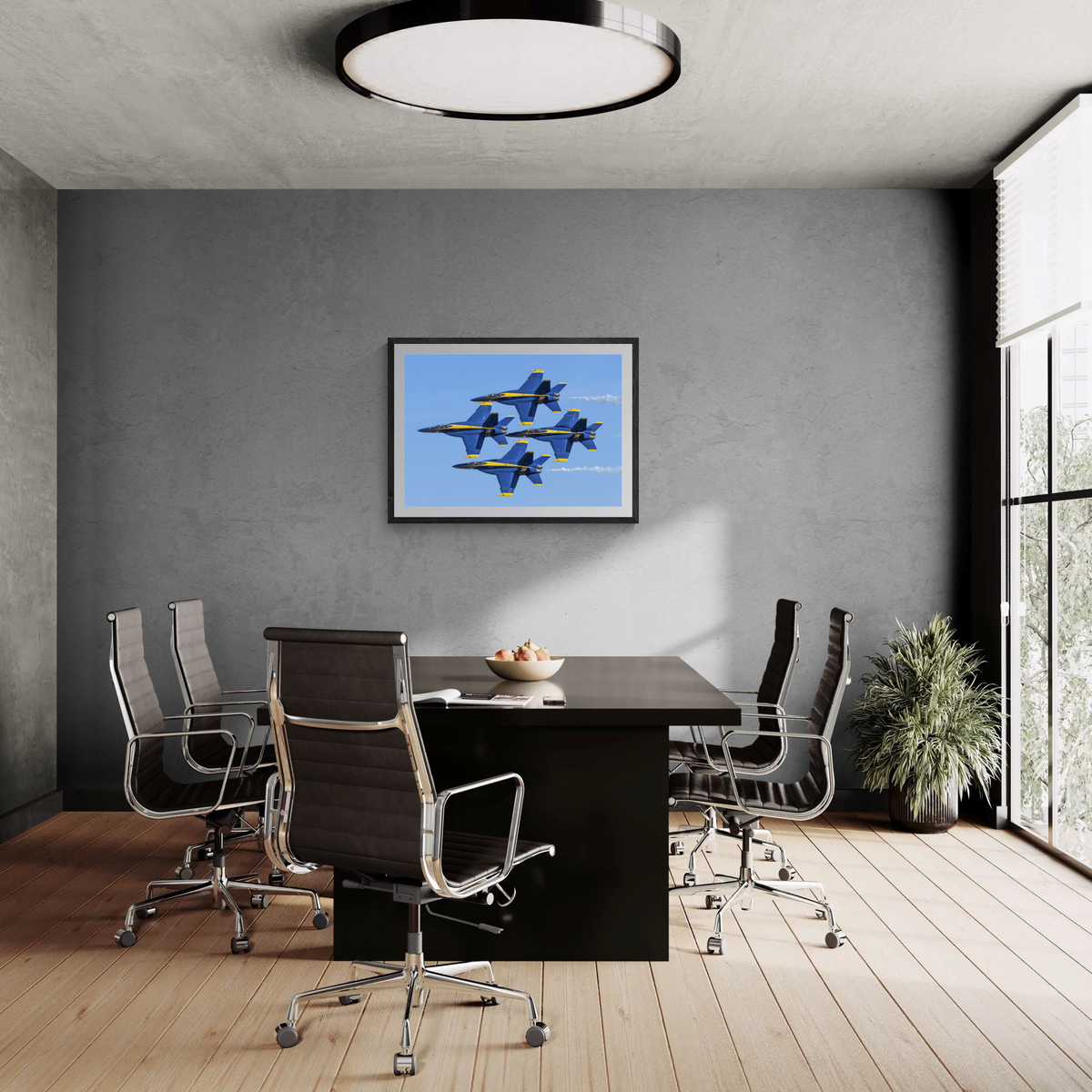 Large framed statement print of the Blue Angels Diamond formation centered on a gray wall above a conference table.