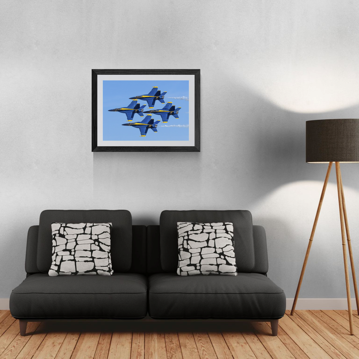 Framed fine art aviation print of The Blue Diamond formation hanging above a modern dark gray sofa.